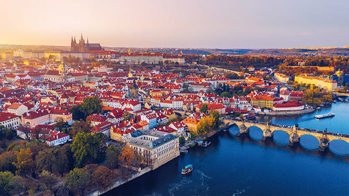 An aerial view of Charles Bridge in Prague at sunset